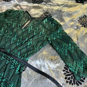 Lacy dress green and black knee length.